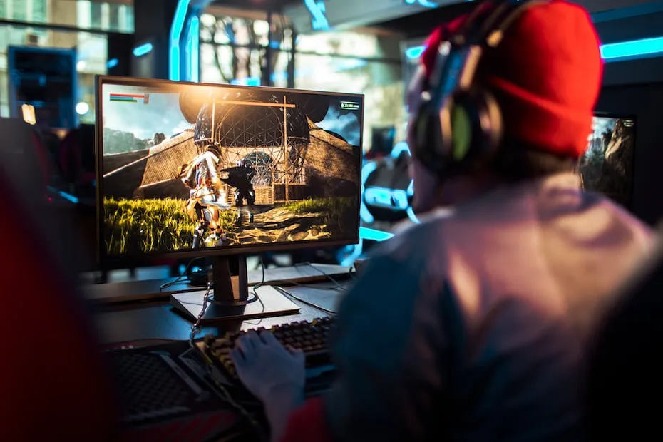 A person wearing headphones is playing a video game